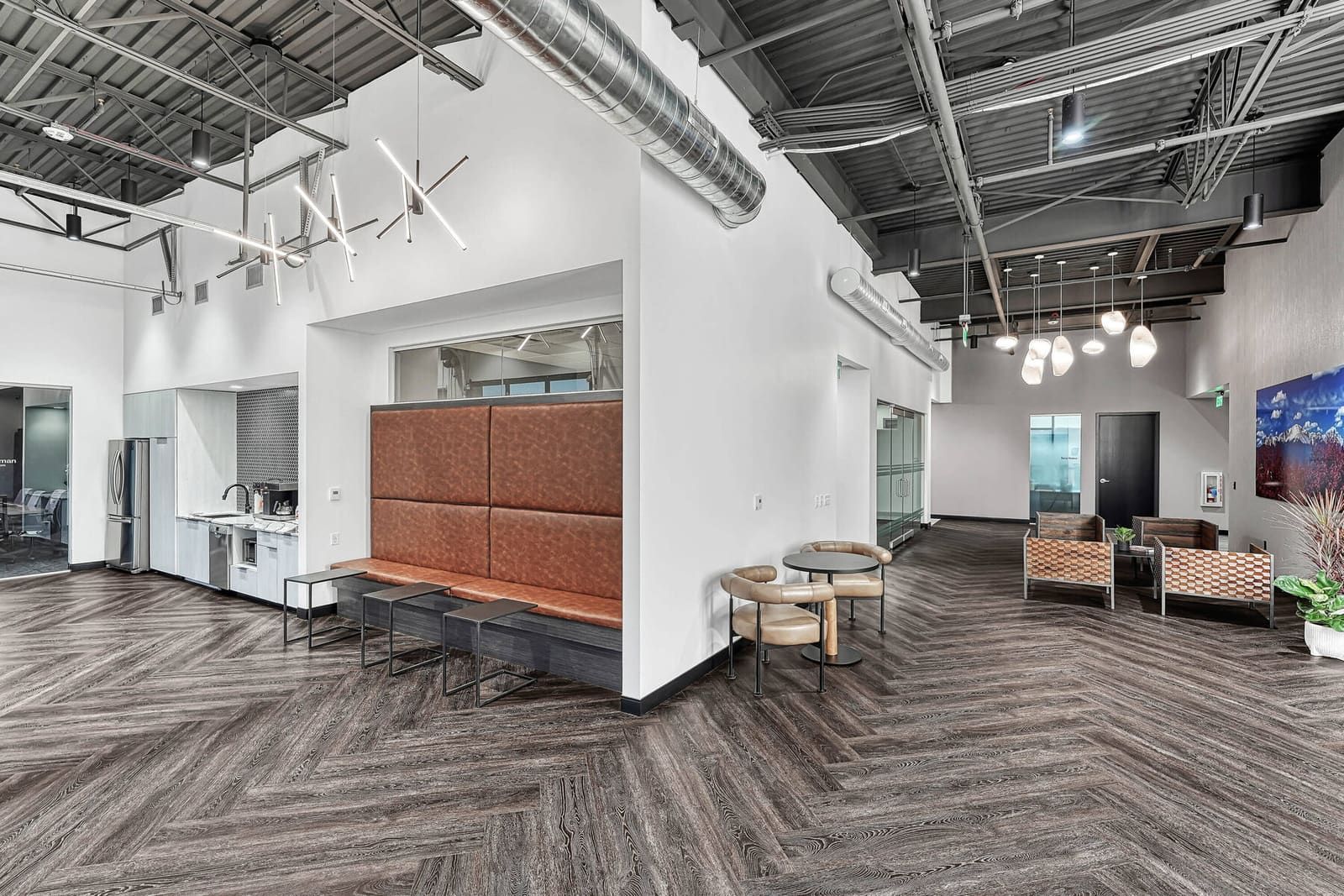 Open common area lounge with herringbone floors