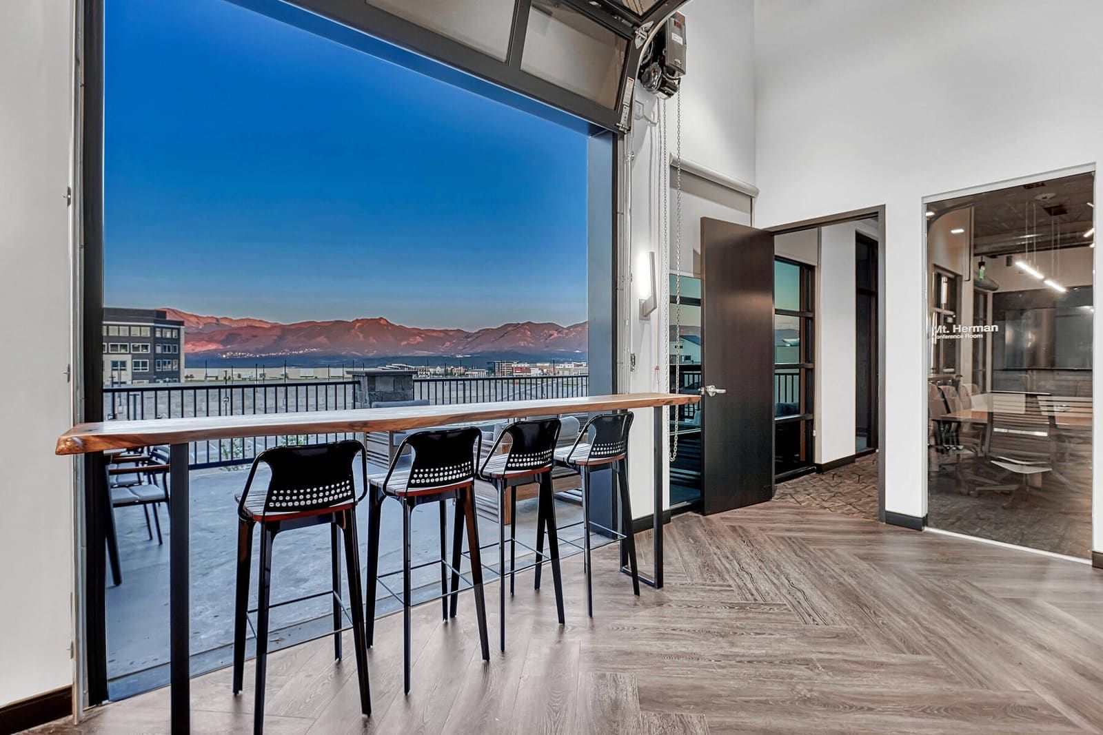 Café-style kitchen with garage door open to mountain views